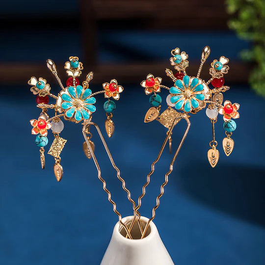 Discover the beauty and versatility of the Chinese Hairpin Set Collection. This curated collection features a variety of traditional Chinese hairpins, each exquisitely designed with intricate details and cultural significance. From floral-inspired designs to ornate motifs, this collection offers a range of options to complement your Hanfu ensemble or add a touch of elegance to any hairstyle.