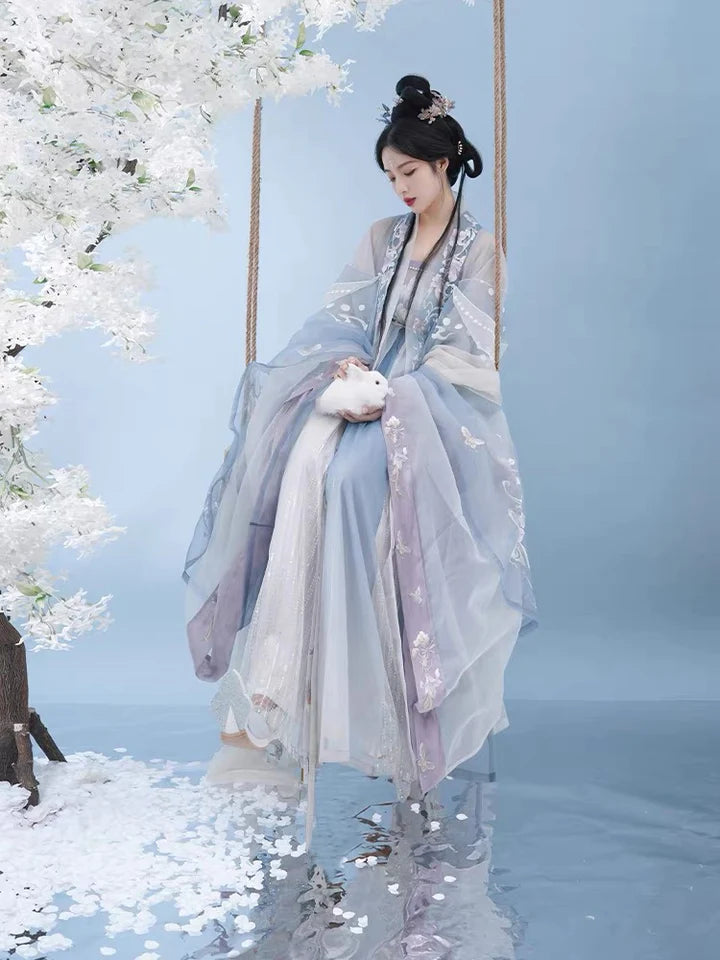 Indulge in the allure of the Tang Dynasty with our Serene Hezi Qun, Tranquil Lavender ensemble—a graceful homage to an era of shifting styles and the iconic influence of Yang Guifei. Immerse yourself in the blend of tradition and contemporary elegance with our Tang Dynasty-inspired Qixiong Ruqun, featuring a regal "Da Xiu Shan" coat. Step out in style, echoing the fashion of centuries past.
