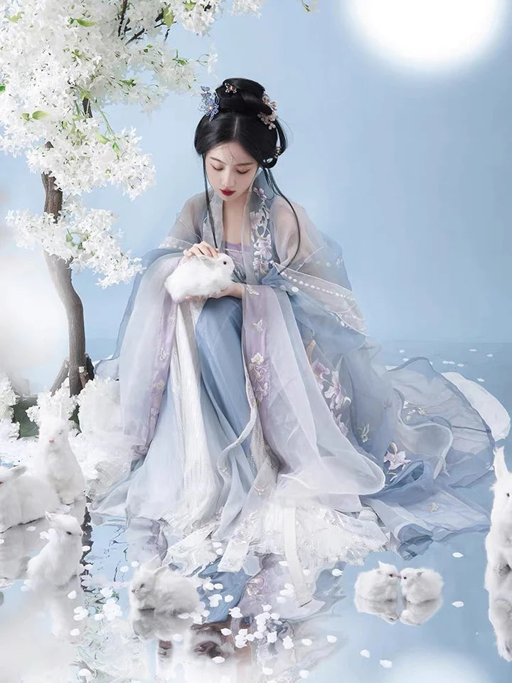 Indulge in the allure of the Tang Dynasty with our Serene Hezi Qun, Tranquil Lavender ensemble—a graceful homage to an era of shifting styles and the iconic influence of Yang Guifei. Immerse yourself in the blend of tradition and contemporary elegance with our Tang Dynasty-inspired Qixiong Ruqun, featuring a regal "Da Xiu Shan" coat. Step out in style, echoing the fashion of centuries past.