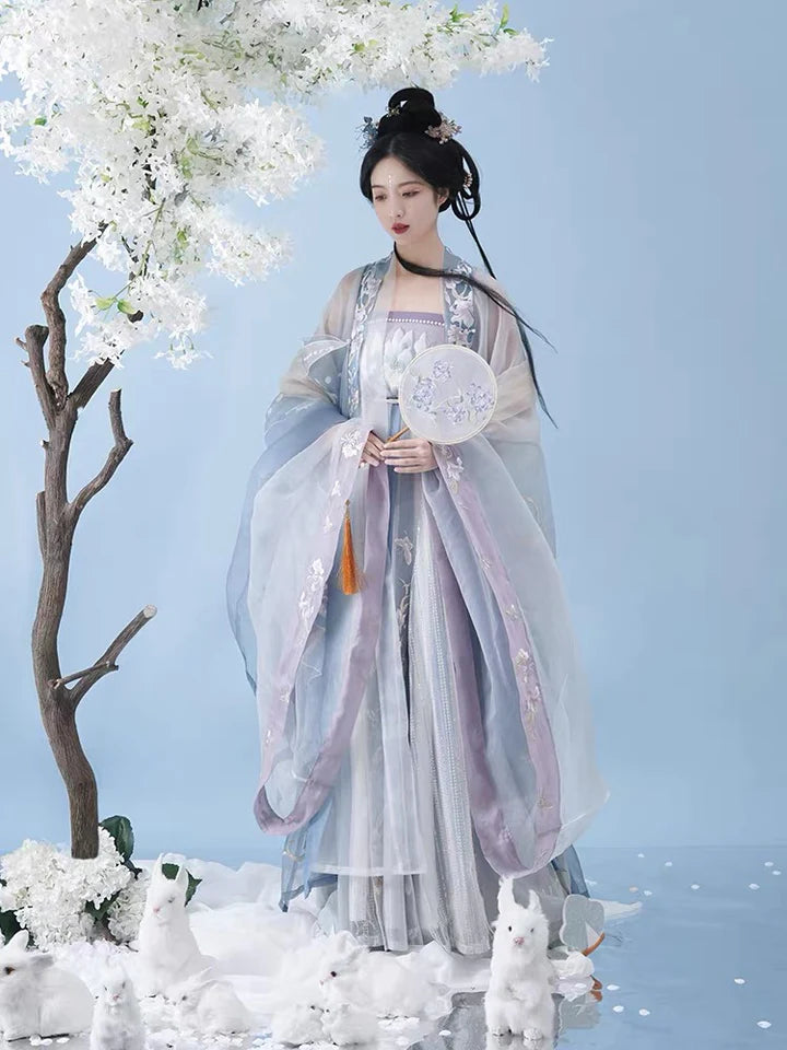 Indulge in the allure of the Tang Dynasty with our Serene Hezi Qun, Tranquil Lavender ensemble—a graceful homage to an era of shifting styles and the iconic influence of Yang Guifei. Immerse yourself in the blend of tradition and contemporary elegance with our Tang Dynasty-inspired Qixiong Ruqun, featuring a regal "Da Xiu Shan" coat. Step out in style, echoing the fashion of centuries past.