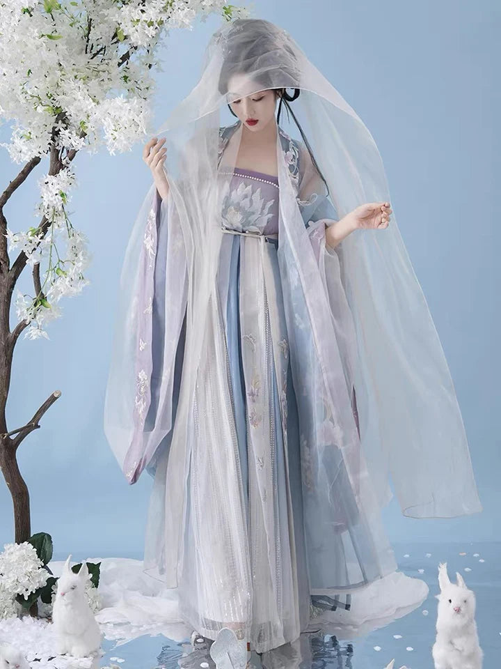 Indulge in the allure of the Tang Dynasty with our Serene Hezi Qun, Tranquil Lavender ensemble—a graceful homage to an era of shifting styles and the iconic influence of Yang Guifei. Immerse yourself in the blend of tradition and contemporary elegance with our Tang Dynasty-inspired Qixiong Ruqun, featuring a regal "Da Xiu Shan" coat. Step out in style, echoing the fashion of centuries past.