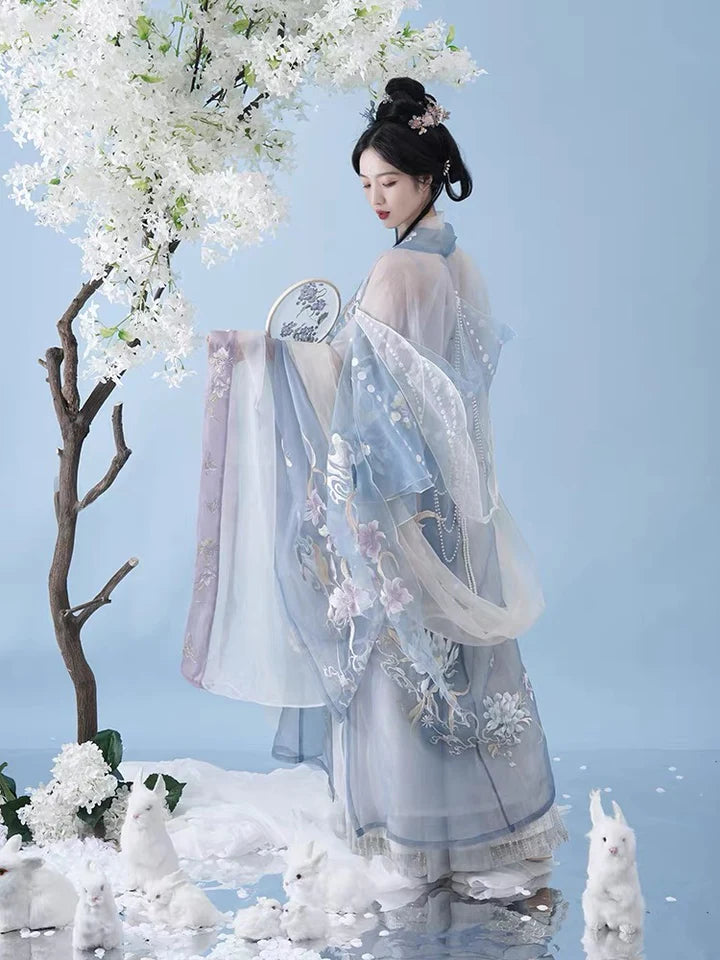 Indulge in the allure of the Tang Dynasty with our Serene Hezi Qun, Tranquil Lavender ensemble—a graceful homage to an era of shifting styles and the iconic influence of Yang Guifei. Immerse yourself in the blend of tradition and contemporary elegance with our Tang Dynasty-inspired Qixiong Ruqun, featuring a regal "Da Xiu Shan" coat. Step out in style, echoing the fashion of centuries past.