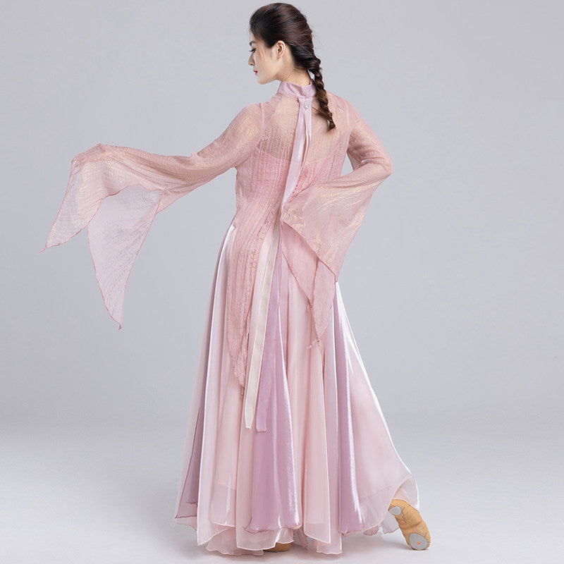 Full back view of a pink dance outfit with a long split-back sheer top and layered skirt