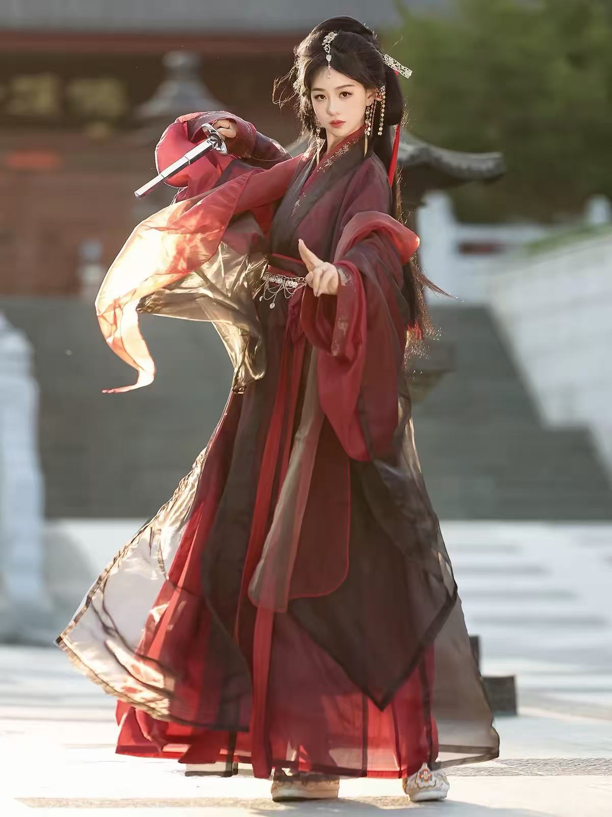 Side view of Yu Ji Tan burgundy and black hanfu, showing the long silhouette and translucent outer layers.