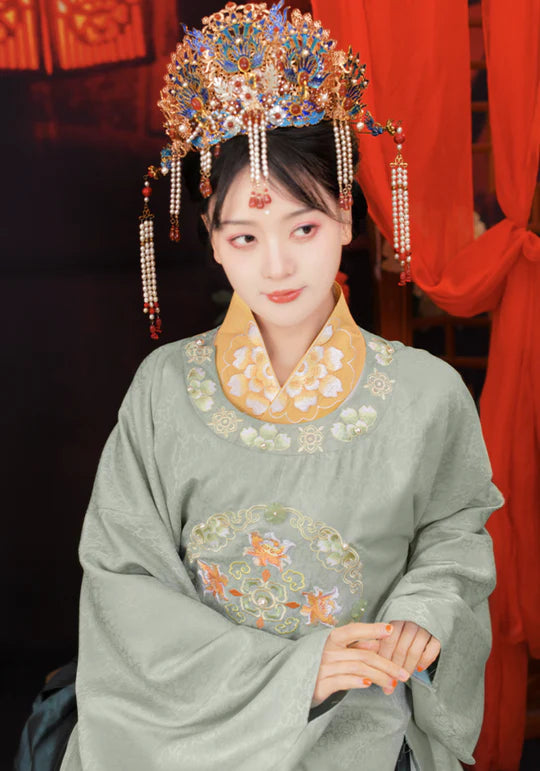 Step into the symphony of love with Harmony Zither Bridal, Ming. This exquisite gown pays homage to the Ming Dynasty&