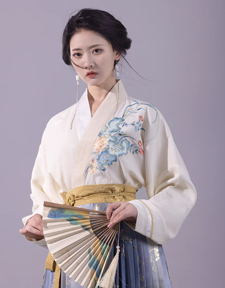 Elevate your style with the Enchanting Whimsy Modern Hanfu Ensemble, a harmonious blend of modern sophistication and timeless beauty. Immerse yourself in the allure of our Modern Hanfu collection, seamlessly capturing the essence of tradition with a contemporary touch. Discover the sophistication and grace of traditional Chinese fashion with the Enchanting Whimsy.