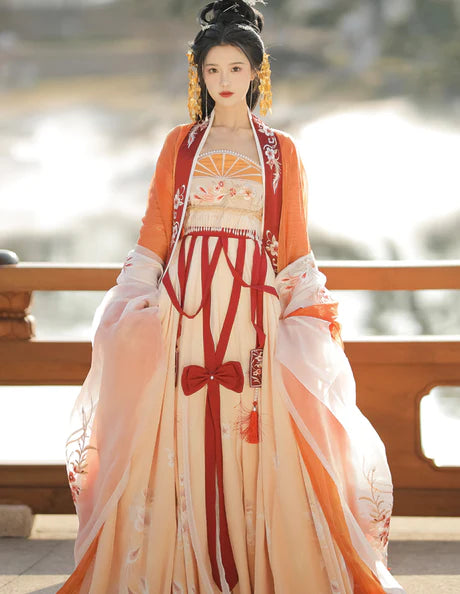 Immerse yourself in the vibrant spirit of the Hezi Qun, beautifully captured in the Cheery Clementine ensemble. This captivating attire seamlessly blends tradition with a touch of contemporary charm. Step into the lively allure of this outfit, embodying a cheery and timeless style that adds a burst of citrus charm to your wardrobe.