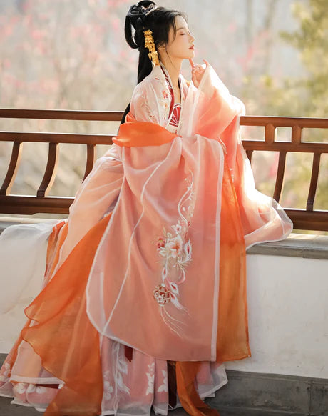 Immerse yourself in the vibrant spirit of the Hezi Qun, beautifully captured in the Cheery Clementine ensemble. This captivating attire seamlessly blends tradition with a touch of contemporary charm. Step into the lively allure of this outfit, embodying a cheery and timeless style that adds a burst of citrus charm to your wardrobe.