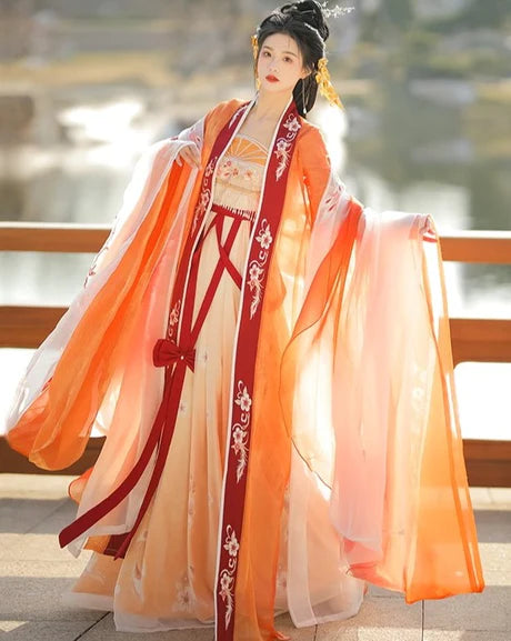 Immerse yourself in the vibrant spirit of the Hezi Qun, beautifully captured in the Cheery Clementine ensemble. This captivating attire seamlessly blends tradition with a touch of contemporary charm. Step into the lively allure of this outfit, embodying a cheery and timeless style that adds a burst of citrus charm to your wardrobe.