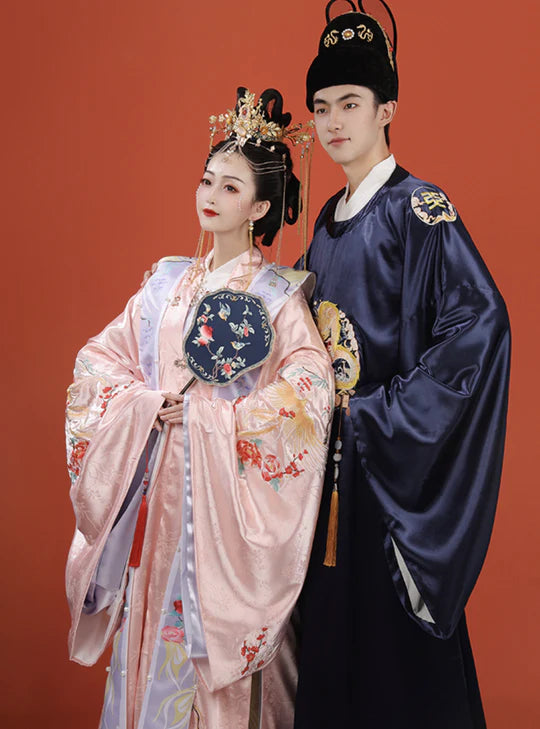 Immerse yourself in the timeless charm of Lunar Dynasty Groom, Ming—an ensemble that echoes the grandeur of the Ming Dynasty. Elevate your wedding day with regal sophistication and celestial allure, making a statement that transcends eras.