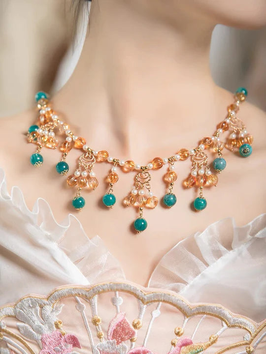 Infuse a burst of freshness into your style with the Juicy Melon Hanfu Necklace, an ideal enhancement for your Hanfu, Cheongsam, and Bridal Gowns. Discover the unique charm of this traditional Han Chinese accessory, transformed into a captivating necklace with intricate details. Explore our curated collection at Moon Hanfu and adorn yourself with the delicious allure of traditional Chinese jewelry.