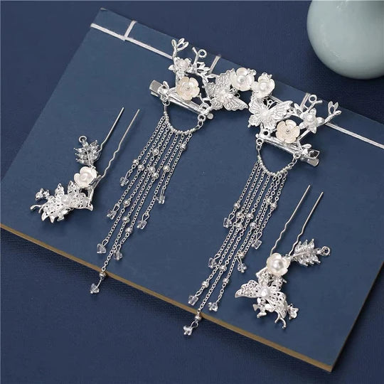 Silvermoon Hanfu Hair Adornments - Elevate your style with the enchanting Silvermoon Hanfu Hair Accessories collection, designed to add a touch of elegance and shine to your ensemble. From intricately designed hairpins (发簪, fāzān) to stylish hair combs (发篦, fābì), graceful tassels (流苏, liúsū), ornate hair ornaments (发髻, fājì), and versatile hairbands and headpieces (发饰, fāshì), each piece is meticulously crafted to enhance your appearance and express your unique style with a touch of silver allure.