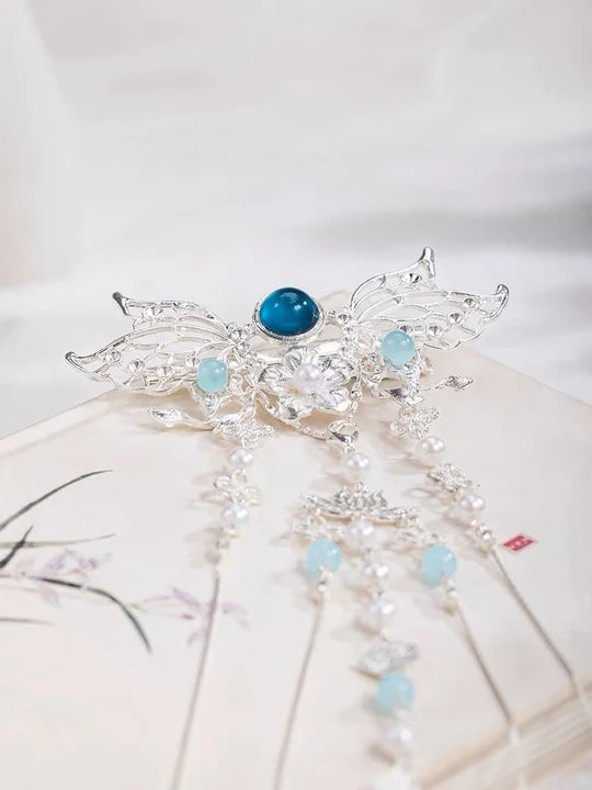 Elevate your style with the exquisite Gemstone Hanfu Hair Accessories collection, designed to add a touch of luxury and brilliance to your ensemble. From intricately designed hairpins (发簪, fāzān) to stylish hair combs (发篦, fābì), graceful tassels (流苏, liúsū), ornate hair ornaments (发髻, fājì), and versatile hairbands and headpieces (发饰, fāshì), each piece features stunning gemstones that enhance your appearance and express your unique style with the captivating allure of precious gems.