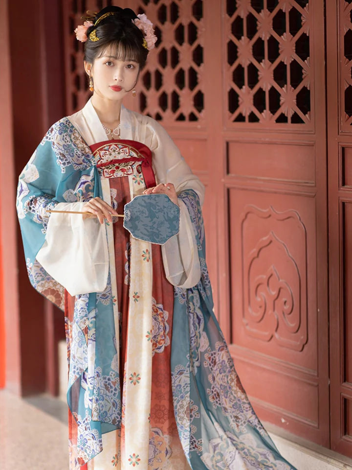 Immerse yourself in the allure of the Tang Dynasty with our Timeless Qixiong Ruqun Ensemble, paying tribute to an era when style reflected societal shifts. Influenced by Yang Guifei, this ensemble captures the preference for plumper figures, encapsulating a unique chapter in feminine ideals. The regal &quot;Da Xiu Shan&quot; coat, adorned with Flourishing Paisley, merges tradition with contemporary elegance. Step out in style, embracing timeless influence with a nod to centuries past.