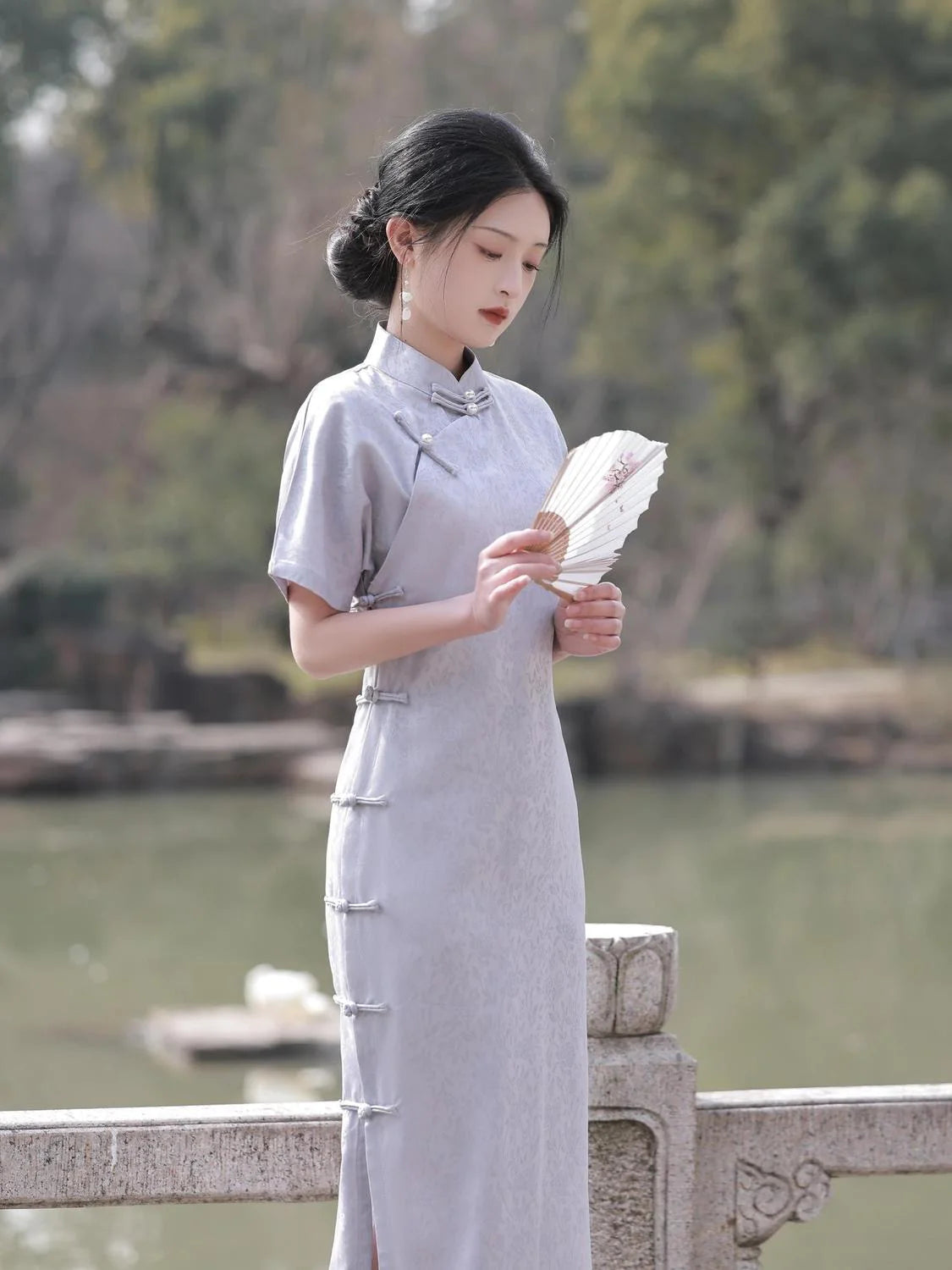 Embrace timeless elegance with the Elegant Short Sleeve Qipao in Grey—a blend of tradition, femininity, and style from Moon Hanfu&