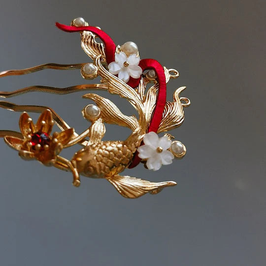 Goldfish Hanfu Hairpin - Embrace playful elegance with the Goldfish Hanfu Hairpin. Its delicate design captures the whimsical beauty of goldfish, perfect for adding a unique flair to your Hanfu-inspired style. Make a statement with this eye-catching hairpin.