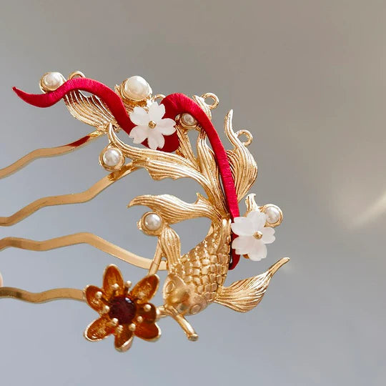 Goldfish Hanfu Hairpin - Embrace playful elegance with the Goldfish Hanfu Hairpin. Its delicate design captures the whimsical beauty of goldfish, perfect for adding a unique flair to your Hanfu-inspired style. Make a statement with this eye-catching hairpin.