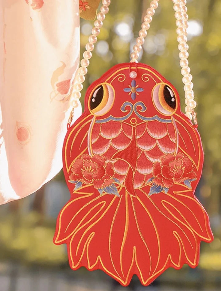 Dive into style with the Opulent Goldfish Embroidered Phone Bag. Explore our curated collection at Moon Accessories for a fashionable and functional accessory adorned with intricate goldfish embroidery, adding a touch of aquatic elegance to your ensemble.