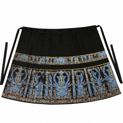 Flat view of the black tie-waist mamian skirt with blue phoenix motifs, gold borders and pleated sides