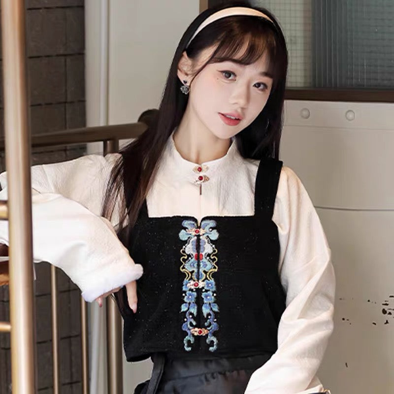 White standing-collar shirt layered beneath a black zhuyao bodice with blue ornamental detailing