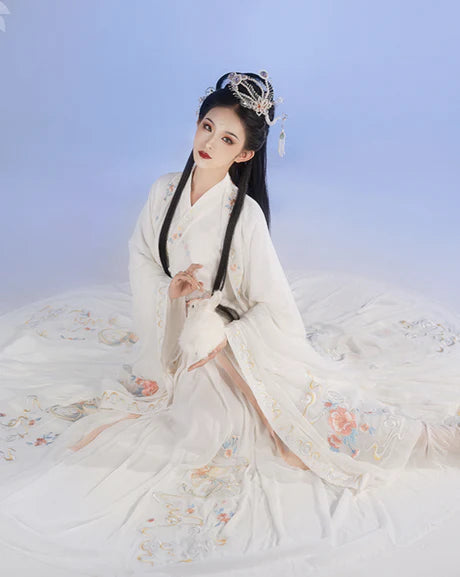 Whisper into elegance with Whisper Jiaoling Ruqun, an enchanting homage to the grace of the Wei Jin Dynasty. Immerse yourself in the distinctive style of cross-collared and wide-sleeved garments, inspired by the iconic Jin Ru 晋襦 and Za Ju 杂裾 fashion trends. Elevate your connection to Chinese tradition through Moon Hanfu&